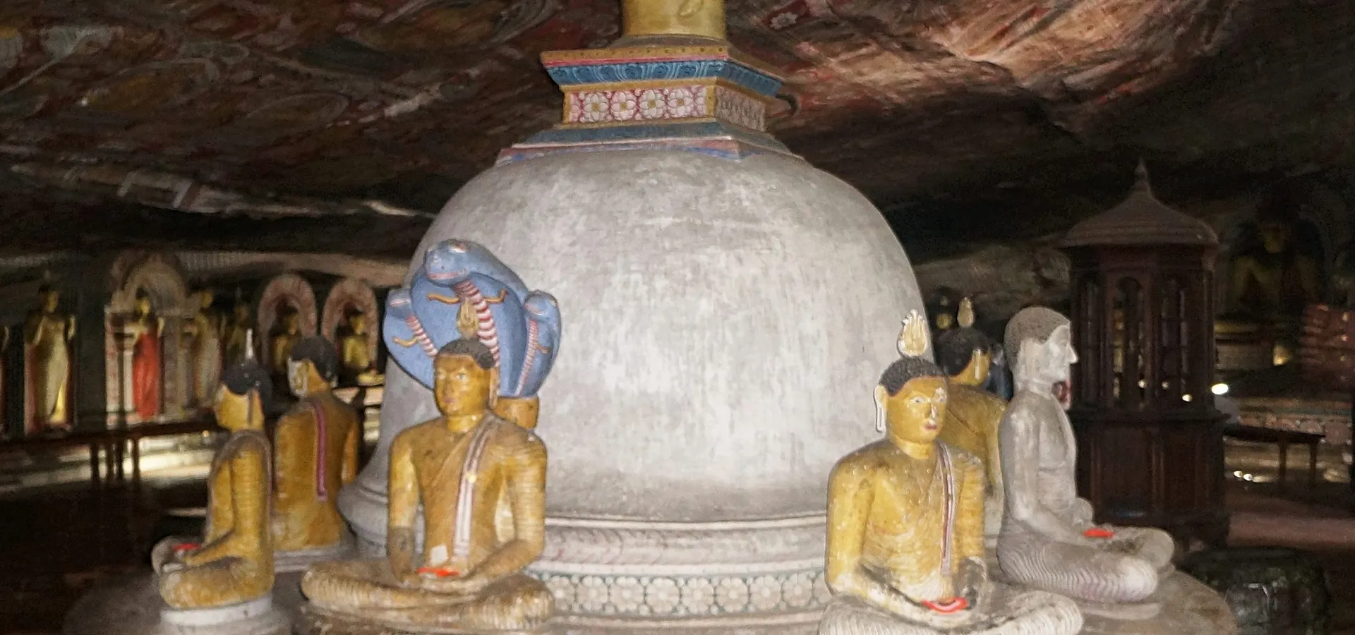 Buddha statues and a stupa inside the Dambulla cave temple
