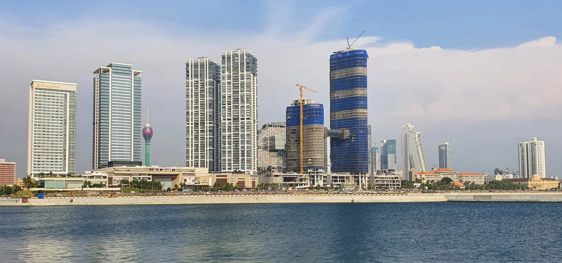 The Colombo skyline rising behind the Indian Ocean waterfront